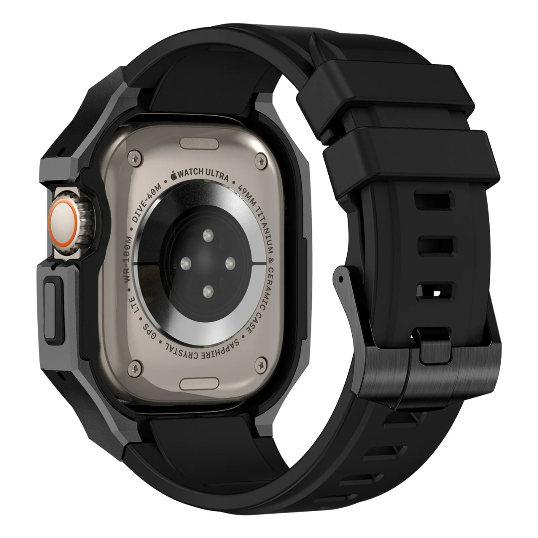 Back of an apple watch in a black protective band and case with metallic back on a white background