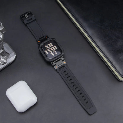 black apple watch band and case, layed down on a black table next to air pods and a black notebook