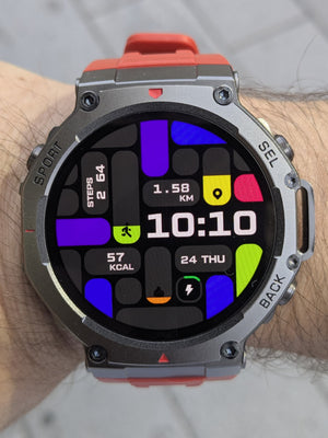 Smartwatch with a colorful display on a wrist, worn on a gray pavement background
